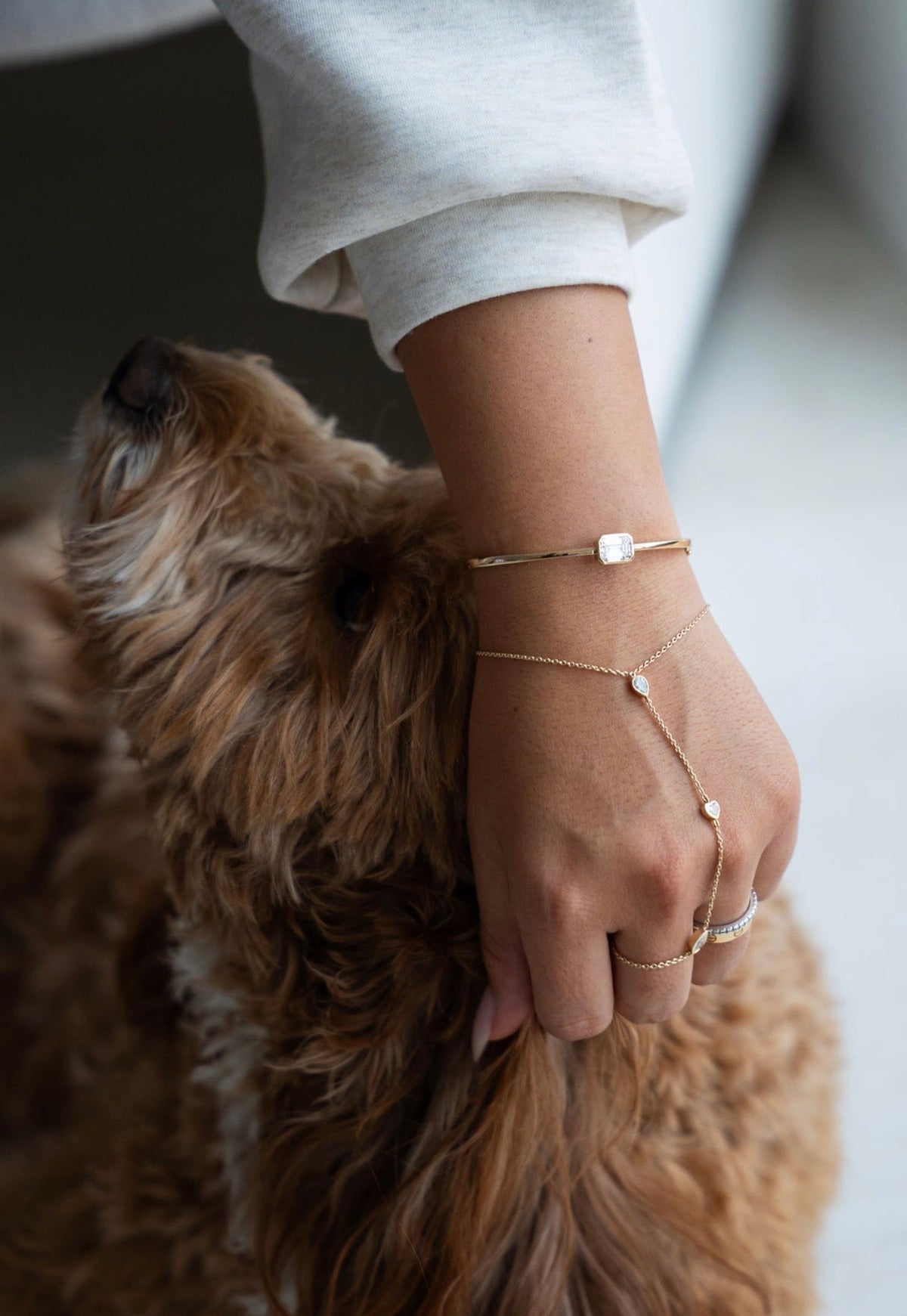 The Emerald Diamond Bangle and the Avra Hand Chain worn together
