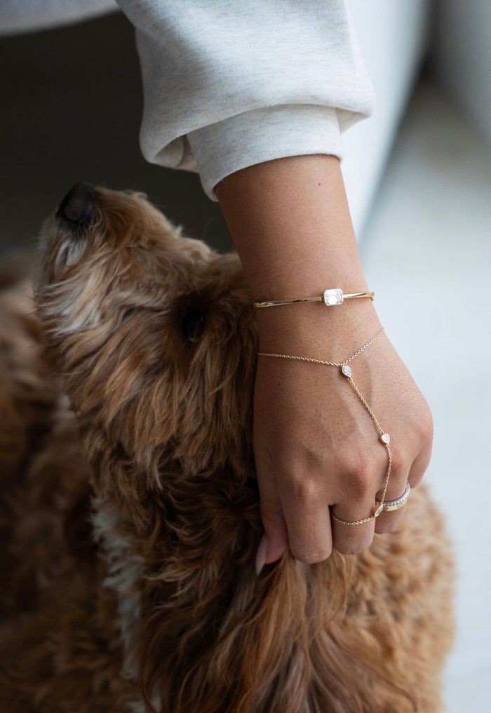 The Emerald Diamond Bangle and the Avra Hand Chain worn together