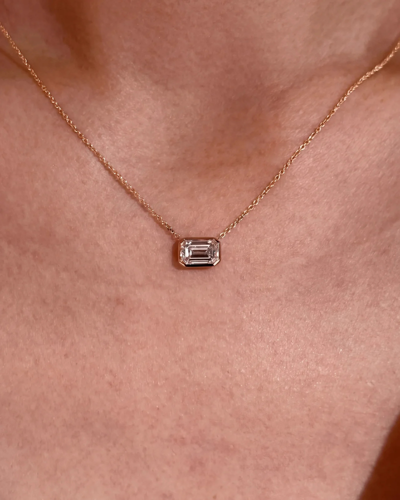 Emerald Necklace — close-up of the gold bezel and bail, solid 14k gold with an emerald-cut lab-grown diamond