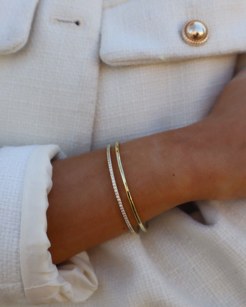 The 14K Gold Bangle stacked with the Half-Pavé Diamond Bangle on the wrist